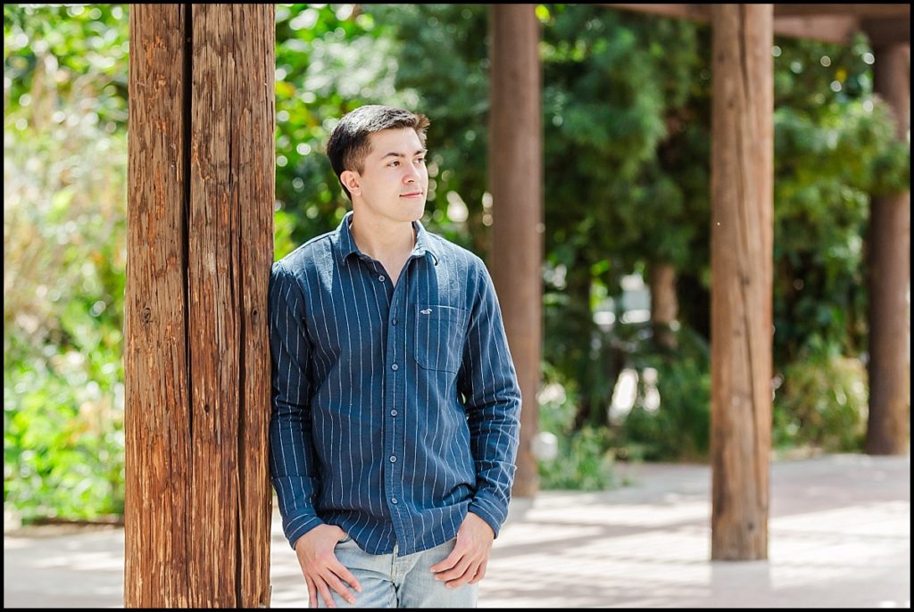 Boy Leaning on Post during High School Senior Portrait at Heritage Square in Phoenix