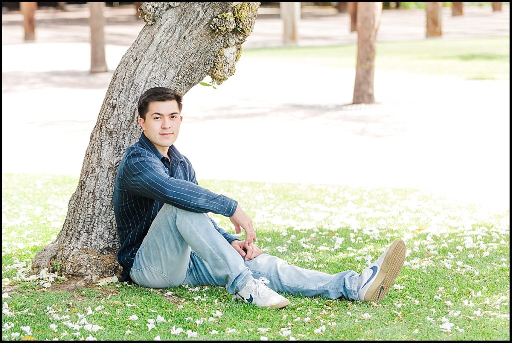 Boy Sitting Under Tree during High School Senior Portrait at Heritage Square in Phoenix