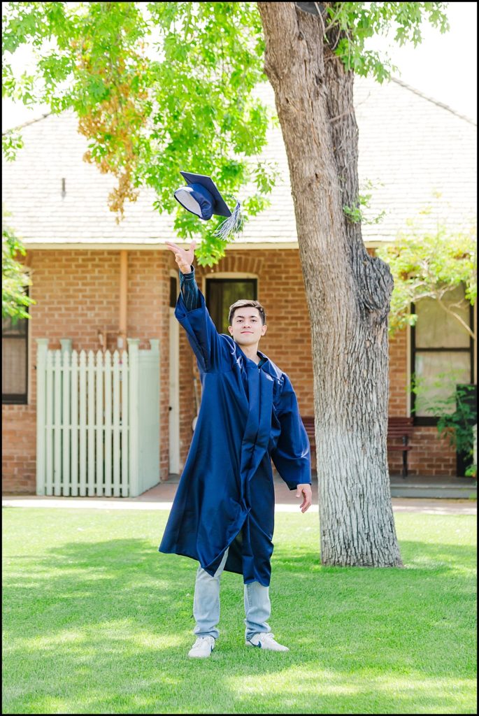 Boy tossing graduation cap during High School Senior Portrait at Heritage Square in Phoenix
