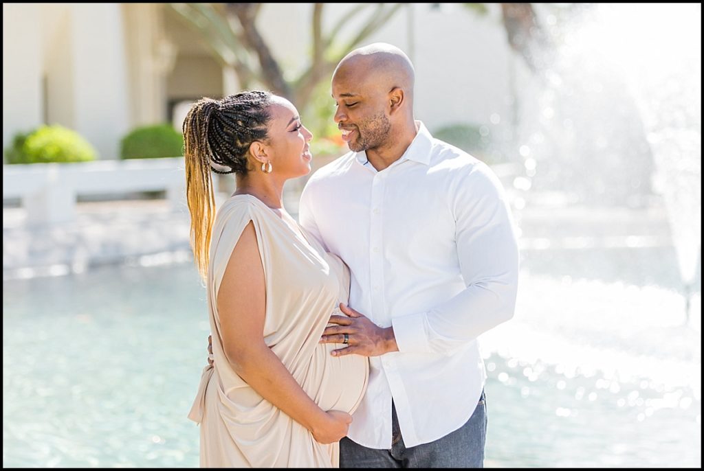 picture of a pregnant African American women in a tan maternity gown and her husband at Scottsdale Civic Center